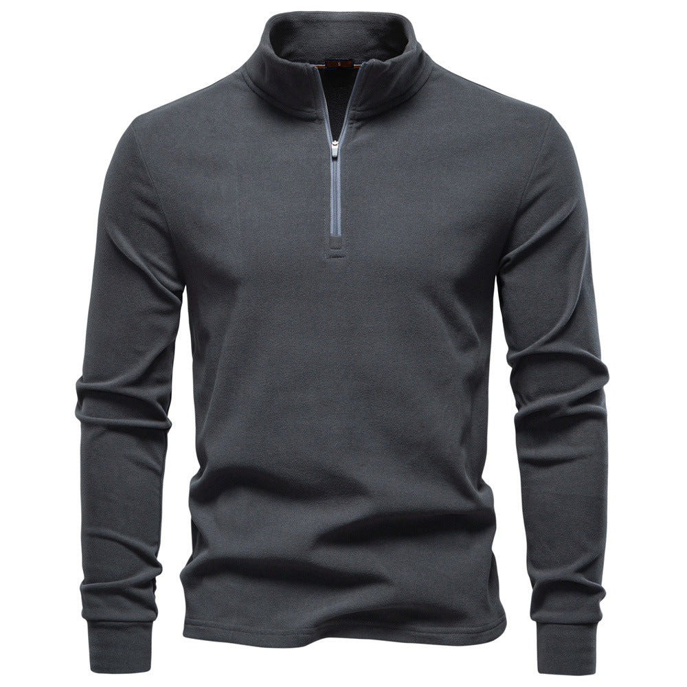 Men’s GeToday half-zip thermal base-layer gym wear, close-up of black fabric with zipper, designed for athletic and cold-weather workouts.